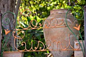 SICILY  ITALY: CASA CUSENI IN TAORMINA - CASA CUSENI WRITTEN IN THE GARDEN RAILINGS  BEHIND A LARGE TERRACOTTA URN WHICH KITSON WAS FOND OF FILLING WITH PLANTS