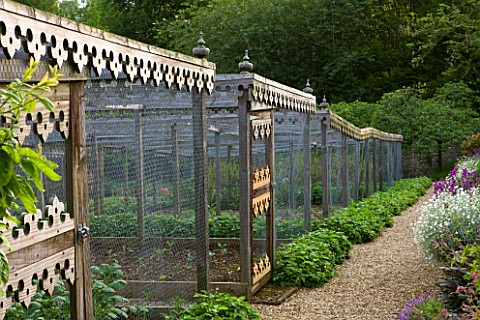 ROCKCLIFFE_HOUSE__GLOUCESTERSHIRE_PATH_THROUGH_THE_WALLED_KITCHEN_GARDEN_WITH_ORNATE_FRETWORK_FRUIT_