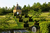 ROCKCLIFFE HOUSE  GLOUCESTERSHIRE: VIEW TO THE MEADOW WITH OXE- EYE - DAISIES  STONE DOVECOT AND TOPIARY BIRDS