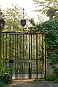 ROCKCLIFFE HOUSE, GLOUCESTERSHIRE: METAL GATE INTO THE GARDEN - ORNAMENT