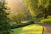 ROCKCLIFFE HOUSE, GLOUCESTERSHIRE: THE FRONT DRIVE AT DAWN WITH LAWN AND TREES - GREEN, DAWN