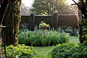 ROCKCLIFFE HOUSE, GLOUCESTERSHIRE: ENCLOSED GARDEN WITH YEW HEDGING AND CENTRAL BED PLANTED WITH WHITE IRIS - GREEN, SECRET GARDEN, COUNTRY GARDEN