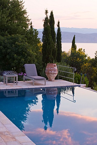 CORFU_GREECE__THE_KASSIOPIA_ESTATE_THE_SWIMMING_POOL_WITH_SUN_LOUNGER_AND_TERRACOTTA_ON_THE_TERRACE_