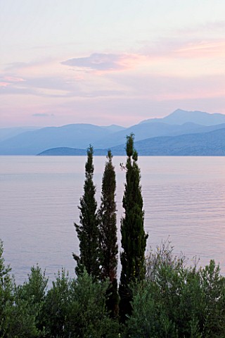 CORFU_GREECE__THE_KASSIOPIA_ESTATE_VIEW_LOOKING_OUT_TO_SEA_WITH_CYPRESS_TREES_AND_THE_ALBANIAN_MOUNT