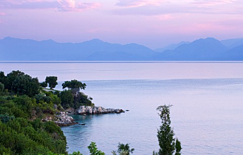 CORFU_GREECE__THE_KASSIOPIA_ESTATE_VIEW_OUT_TO_SEA_WITH_ALBANIAN_MOUNTAINS_IN_THE_DISTANCE