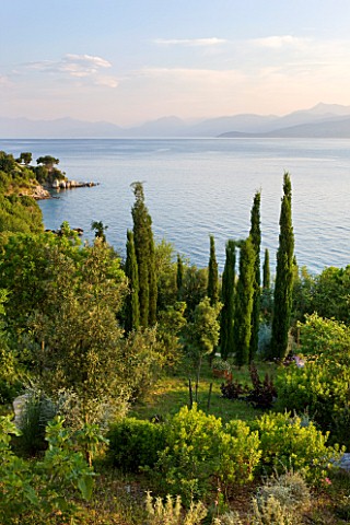 CORFU_GREECE__THE_KASSIOPIA_ESTATE_VIEW_OUT_TO_SEA_WITH_ALBANIAN_MOUNTAINS_IN_THE_DISTANCE_WITH_OLIV