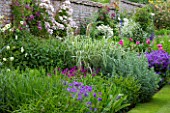 BIRTSMORTON COURT, WORCESTERSHIRE: THE WALLED GARDEN - BORDER WITH PEONIES, TRADESCANTIA, CLEMATIS, ROSES, GERANIUMS, SUMMER, JUNE, WALL, WALLS, HERBACEOUS