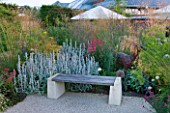 HORATIOS GARDEN  SALISBURY HOSPITAL  WILTSHIRE - DESIGNER CLEEVE WEST - SEAT/BENCH WITH BORDER OF STACHYS  CENTRANTHUS RUBER AND STIPA GIGANTEA