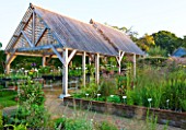 MARCHANTS HARDY PLANTS, EAST SUSSEX: THE NURSERY - TIMBER SHELTER WITH LATH ROOF. WOOD