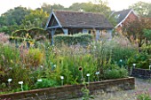 MARCHANTS HARDY PLANTS, EAST SUSSEX: THE NURSERY - RAISED BEDS WITH PLANTS AND NURSERY SHED