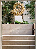 DESIGNER STEPHEN WOODHAMS, LONDON: ROOF GARDEN - RAISED BEDS, COTSWOLD STONE SCULPTURE BY TOM STOGDON. PATIO, TERRACE, FORMAL, STEP, STEPS, ORNAMENT, CLASSIC, FOCAL POINT