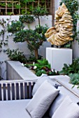 DESIGNER STEPHEN WOODHAMS, LONDON: ROOF GARDEN - RAISED BEDS, COTSWOLD STONE SCULPTURE BY TOM STOGDON. PATIO, TERRACE, FORMAL, ORNAMENT, CLASSIC, FOCAL POINT, CUSHION, SOFA