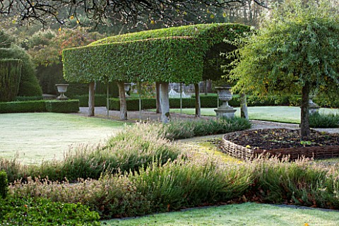 HOLKER_HALL__CUMBRIA_THE_FORMAL_GARDEN_WITH_PORTUGUESE_LAUREL_TUNNEL