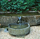 WATER FEATURE: STONE TROUGH SURROUNDED BY HERBS IN THE HERB GARDEN BESIDE THE HOUSE. REDENHAM PARK  HAMPSHIRE