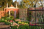 EAST RUSTON OLD VICARAGE GARDEN, NORFOLK: CUTTING GARDEN WITH WALLS AND TULIPS IN BEDS - SPRING, FLOWERS, COUNTRY GARDEN, FLOWER, COLOURFUL