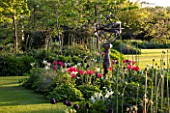 THE OLD VICARAGE, WORMLEIGHTON, WARWICKSHIRE: DESIGNER - ANGEL COLLINS - PINK TULIPS IN THE SUNDIAL BED WITH IN MIDDLE OF LAWN - FORMAL GARDEN, CLASSIC COUNTRY GARDEN