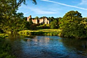 HADDON HALL, DERBYSHIRE: THE HALL SEEN FROM THE RIVER WYE IN JUNE - EVENING LIGHT
