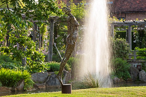 GREAT_FOSTERS_SURREY__SOARING_FIGURE__SCULPTURE_IN_STAINLESS_STEEL_BY_RICK_KIRBY_BESIDE_THE_MOAT__WA