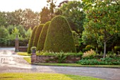 GREAT FOSTERS, SURREY: FRONT GARDEN OF THE HOTEL WITH DRIVE AND CLIPPED TOPIARY SHAPES - YEW, VIEWPOINT, FRAME, FRANING, JUNE, COUNTRY GARDEN, PATTERN