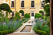 PRIVATE GARDEN, GLOUCESTERSHIRE - DESIGNER ANGEL COLLINS - RILL, CANAL, POOL, POND, WATER WITH AGAPANTHUS. BLUE, FLOWERS, SPOUTING, SPURTING, HOUSE, COUNTRY, GARDEN, FORMAL