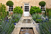 PRIVATE GARDEN, GLOUCESTERSHIRE - DESIGNER ANGEL COLLINS - RILL, CANAL, POOL, POND, WATER WITH AGAPANTHUS. BLUE, FLOWERS, SPOUTING, SPURTING, HOUSE, COUNTRY, GARDEN, FORMAL