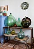 CIUTADELLA MENORCA, SPAIN: EVELYNE MANDEL HOUSE - FRONT ROOM, LIVING ROOM - VINTAGE GLASS JARS / CONTAINERS FROM MENORCA ON TABLE AND SIDEBOARD