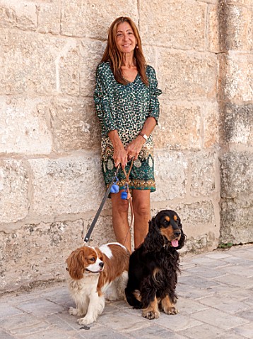 CIUTADELLA_MENORCA_SPAIN_EVELYNE_MANDEL_HOUSE__EVELYN_MANDEL_OUTSIDE_HER_HOUSE_WITH_HER_TWO_DOGS