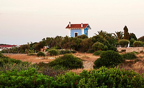 JONATHAN_BAILLIE_GARDEN_ALAIOR_MENORCA_VIEW_OF_THE_BLUE_AND_WHITE_HOUSE_SEEN_FROM_THE_EDGE_OF_THE_TO