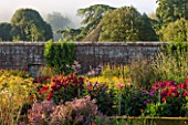 WEST DEAN GARDENS, WEST SUSSEX: DAHLIAS IN THE CUTTING GARDEN - AUGUST, FLOWERS, BLOOM, COLORFUL, MORNING LIGHT, WALLED GARDEN, WALL
