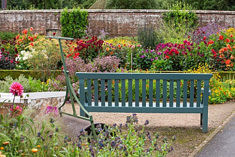 WEST_DEAN_GARDENS_WEST_SUSSEX_THE_CUTTING_GARDEN_IN_AUGUST_WITH_WOODEN_BENCH__SEAT_AND_ROLLER_WALLED