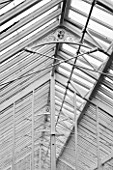 WEST DEAN GARDENS, WEST SUSSEX: BLACK AND WHITE IMAGE OF GLASSHOUSE / GREENHOUSE ROOF IN THE WALLED KITCHEN GARDEN. AUGUST, CLASSIC COUNTRY GARDEN