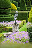 GREAT FOSTERS. SURREY: VIEW OF FORMAL TOPIARY GARDEN IN AUGUST WITH CHERUB STATUE - CLIPPED, SHAPED, EVERGREEN, SHRUBS, HEDGES, HEDGING, CLASSIC COUNTRY GARDEN