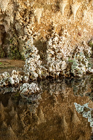 PAINSHILL_PARK_SURREY_THE_CRYSTAL_GROTTO__THE_GROTTO_WITH_REFLECTIONS_IN_WATER__CLASSIC_OOLITIC_LIME