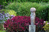 SURREY GARDEN DESIGNED BY ANTHONY PAUL: SEDUMS AND GRASSES AND FOCAL POINT OF POLISHED STONE SCULPTURE BY PAUL VANSTONE - SUMMER, SEPTEMBER, COUNTRY GARDEN
