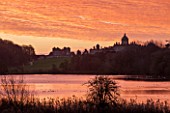 CASTLE HOWARD, YORKSHIRE: CHRISTMAS - SUNRISE OVER THE GREAT LAKE WITH THE HOUSE IN THE BACKGROUND - WINTER, ORANGE, SKY, WATER, POND