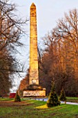 CASTLE HOWARD, YORKSHIRE: CHRISTMAS - CHRISTMAS TREES IN FRONT OF THE OBELISK ON LAWN WITH LIGHTS - WINTER, DECORATION, DECORATIVE, NOVEMBER