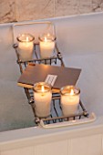 SALTWATER, NORFOLK : DESIGNER KAREN MOORE - CHRISTMAS, DECEMBER, WINTER - BATHROOM IN WHITE AND GREY - CANDLES BY THE BATH - ORNAMENT, DECORATION, LIGHTING
