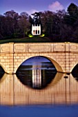 PAINSHILL PARK, SURREY: THE FIVE ARCH BRIDGE AND GOTHIC TEMPLE LIT UP AT NIGHT - LIGHTING, FOLLY, FOLLIES, HISTORIC, LAKE, WATER, LANDSCAPE, WINTER, DECEMBER, CHRISTMAS, REFLECTION