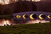 PAINSHILL PARK, SURREY: THE FIVE ARCH BRIDGE LIT UP AT NIGHT - LIGHTING, FOLLY, FOLLIES, HISTORIC, LAKE, WATER, LANDSCAPE, WINTER, DECEMBER, CHRISTMAS, REFLECTION, REFLECTIONS