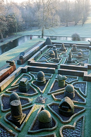 GREAT_FOSTERS_SURREY_VIEW_OVER_FORMAL_TOPIARY_GARDEN_IN_WINTER__CLIPPED_SHAPED_EVERGREEN_SHRUBS_HEDG