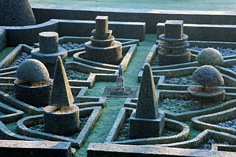 GREAT_FOSTERS_SURREY_VIEW_OVER_FORMAL_TOPIARY_GARDEN_IN_WINTER__CLIPPED_SHAPED_EVERGREEN_SHRUBS_HEDG