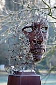 GREAT FOSTERS. SURREY: FIGURE HEAD SCULPTURE BY RICK KIRBY BESIDE THE SAXON MOAT - ART, CLASSIC, FORMAL, COUNTRY GARDEN, WINTER, FROST, JANUARY