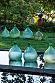 CLOS DU PEYRONNET, MENTON, FRANCE: POOL / POND WITH GLASS BOTTLES / JARS IN WATER. ORNAMENT, FEBRUARY, MEDITERRANEAN