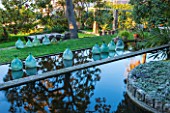 CLOS DU PEYRONNET, MENTON, FRANCE: PONDS / POOLS ON DIFFERENT LEVELS ON SLOPE WITH REFLECTIONS AND GLASS BOTTLES / JARS AS ORNAMENT. TERRACE, TERRACING, SLOING, MEDITERRANEAN