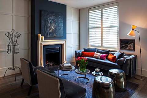 SALLY_STOREY_HOUSE_LONDON_OPEN_PLAN_SITTING_ROOM__HALL_WITH_FIREPLACE_PAINTING_BY_SALLYS_DAUGHTER_LU