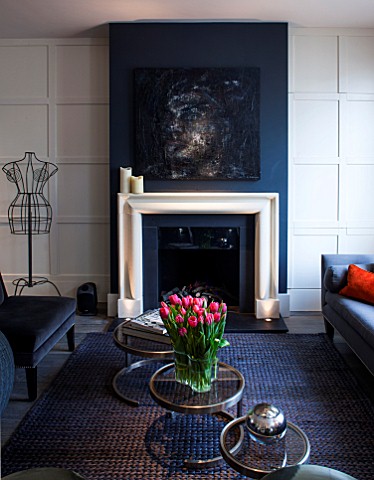 SALLY_STOREY_HOUSE_LONDON_OPEN_PLAN_SITTING_ROOM__HALL_WITH_FIREPLACE_PAINTING_BY_SALLYS_DAUGHTER_LU