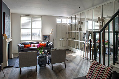 SALLY_STOREY_HOUSE_LONDON_OPEN_PLAN_SITTING_ROOM__HALL_WITH_FIREPLACE_PAINTING_MIRRORED_WALL_MIRROR_