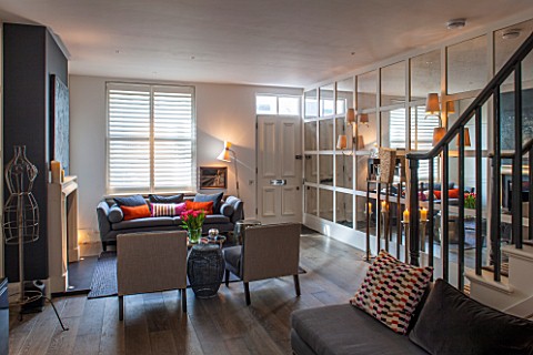 SALLY_STOREY_HOUSE_LONDON_OPEN_PLAN_SITTING_ROOM__HALL_WITH_FIREPLACE_PAINTING_MIRRORED_WALL_MIRROR_