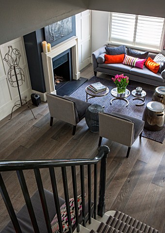 SALLY_STOREY_HOUSE_LONDON_OPEN_PLAN_SITTING_ROOM__HALL_WITH_CHAIRS_RUG_SETTEE_FIREPLACE_PAINTED_FARR