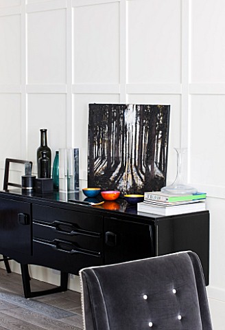 SALLY_STOREY_HOUSE_LONDON_OPEN_PLAN_SITTING_ROOM__HALL_WITH_GREY_CHAIR_AND_BLACK_SIDEBOARD_WITH_PAIN